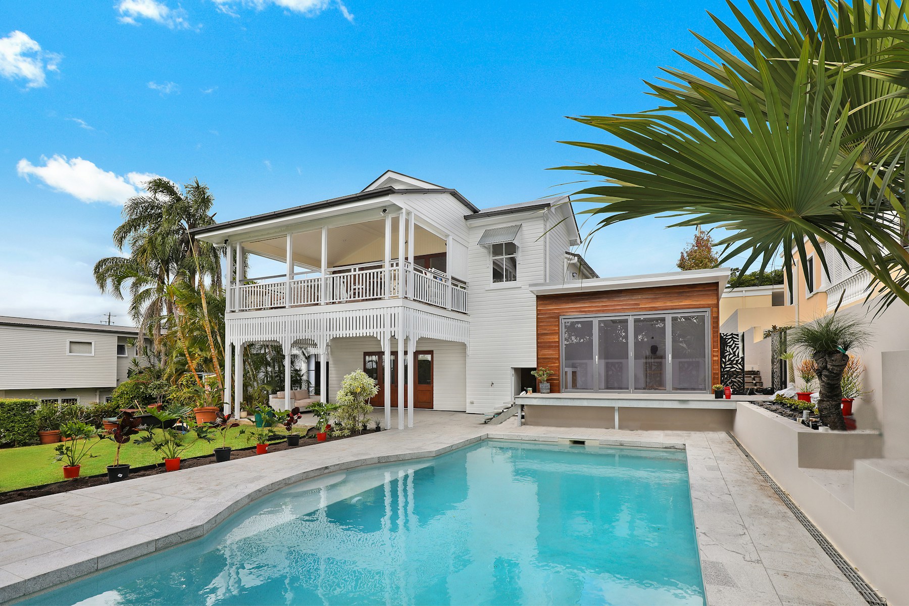 Wide architectural view of a coastal residence with a pool