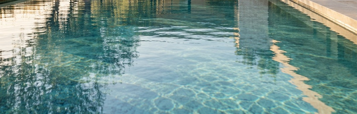 Sunlight playing across a calm pool surface